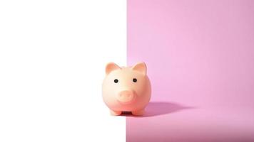 Piggy bank isolated on pink background. Saving money concept. photo