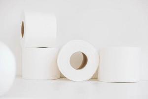 Rolls of white toilet paper on a white background photo