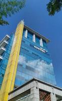 Sukoharjo - May 26, 2022 - very tall mandiri bank building with beautiful blue sky background photo