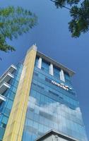 Sukoharjo - May 26, 2022 - very tall mandiri bank building with beautiful blue sky background photo