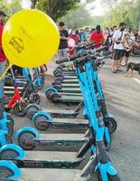 Sukoharjo - June 3, 2022 - Rows of blue electric scooters parked on the side of the road photo