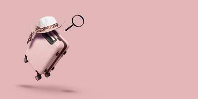 pink suitcase with hat  on pink background. travel concept. minimal style photo