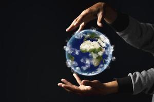 Environment concept. Earth in human hands on black background. Elements of this image furnished by NASA photo