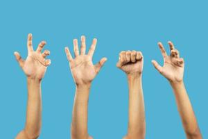 Group of hand gestures isolated over the blue background. photo