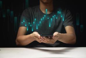 Hand of Businessman or trader showing a growing virtual hologram stock photo