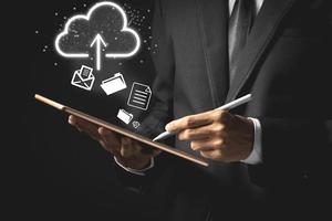 Business man uploading data information on cloud computing network. Cloud computing concept. photo