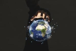 Hand holding earth on dark light background , Elements of image are furnished by NASA photo
