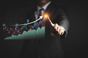 Businessman or trader is showing a growing virtual hologram stock, invest in trading photo