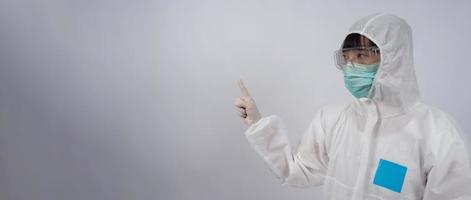 Doctor in PPE suit gesture make hand sign. Represent victory win over virus. photo