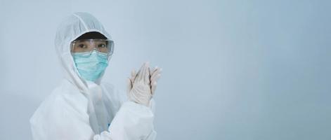 Doctor in PPE suit gesture make hand sign. Represent victory win over virus. photo