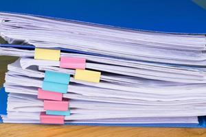Close up Stack of papers files piles with documents achieves with paper clips photo