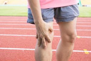 Tendon knee joint problems on Man leg from exercise In the stadium. photo