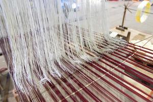 Household Loom weaving - Detail of weaving loom for homemade silk or textile production of Thailand photo