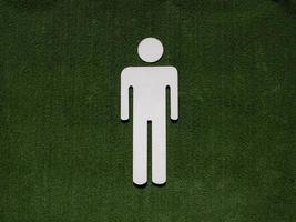 male symbol on fake green grass photo