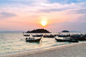 morning sun rise on beach many wooden longtail boats parking photo