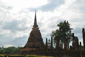 Old pagoda and old viharn with clear sky at the Historical Park in Sukhothai. photo