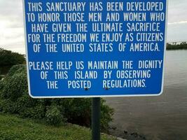 blue veterans sanctuary sign about sacrifice and dignity and water photo