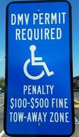 DMV permit required sign with wheelchair and penalty information photo