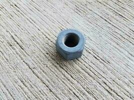 metal bolt with hexagon shape on grey cement photo