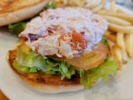 lobster roll sandwich with tomato lettuce and bun photo