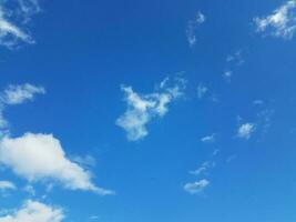 blue sky with white fluffy cumulus clouds photo