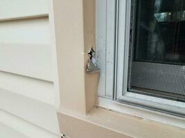 hole or damage in metal window frame photo