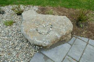 heart shape on boulder with rocks and grey tiles photo