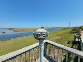 viewfinder or binoculars with water and green grass outdoor photo