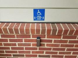 blue press to open wheelchair button and red bricks photo