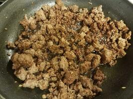 beef and ginger cooking in frying pan photo