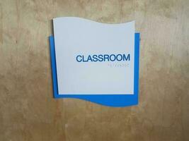 blue classroom sign on door with braille photo