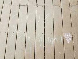 I love you mama written in chalk on wood deck photo