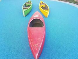 red, yellow, and green kayaks and canoes on blue surface photo