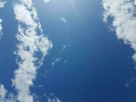 blue sky with clouds and sun photo