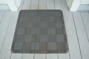 square black rubber mat on wood deck photo