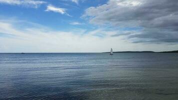 blue calm water and sailboat in Guanica, Puerto Rico photo