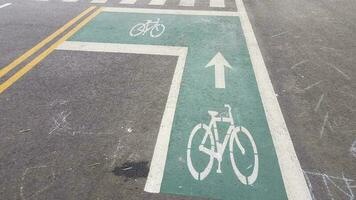 bike lane markings on black asphalt or road photo