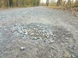 hole or pothole with rocks on trail or path photo