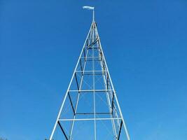 tall metal tower or structure with blue and white flag photo