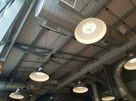 industrial ceiling with vents and hanging lights photo