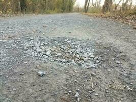 hole or pothole with rocks on trail or path photo