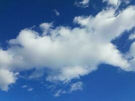 blue sky with white fluffy cumulus clouds photo