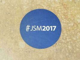 blue sticker on the ground that says JSM2017