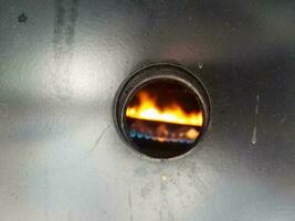 circular hole with hot flames and metal covering photo