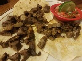 beef taco with tortilla and tomato and lime photo