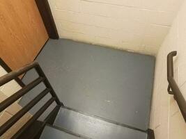 blue stairs with railing and door and white cement bricks photo