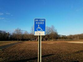 blue DMV permit required wheelchair sign fine and tow away zone photo