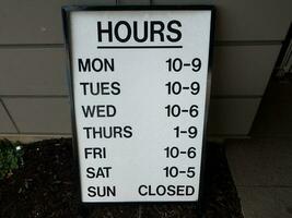 hours sign with days of the week and times photo