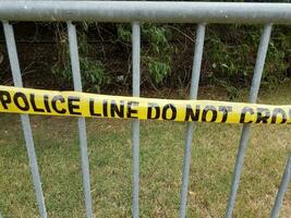 metal bike rack with yellow police line do not cross tape photo