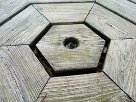 worn brown wood table with hexagon pattern photo